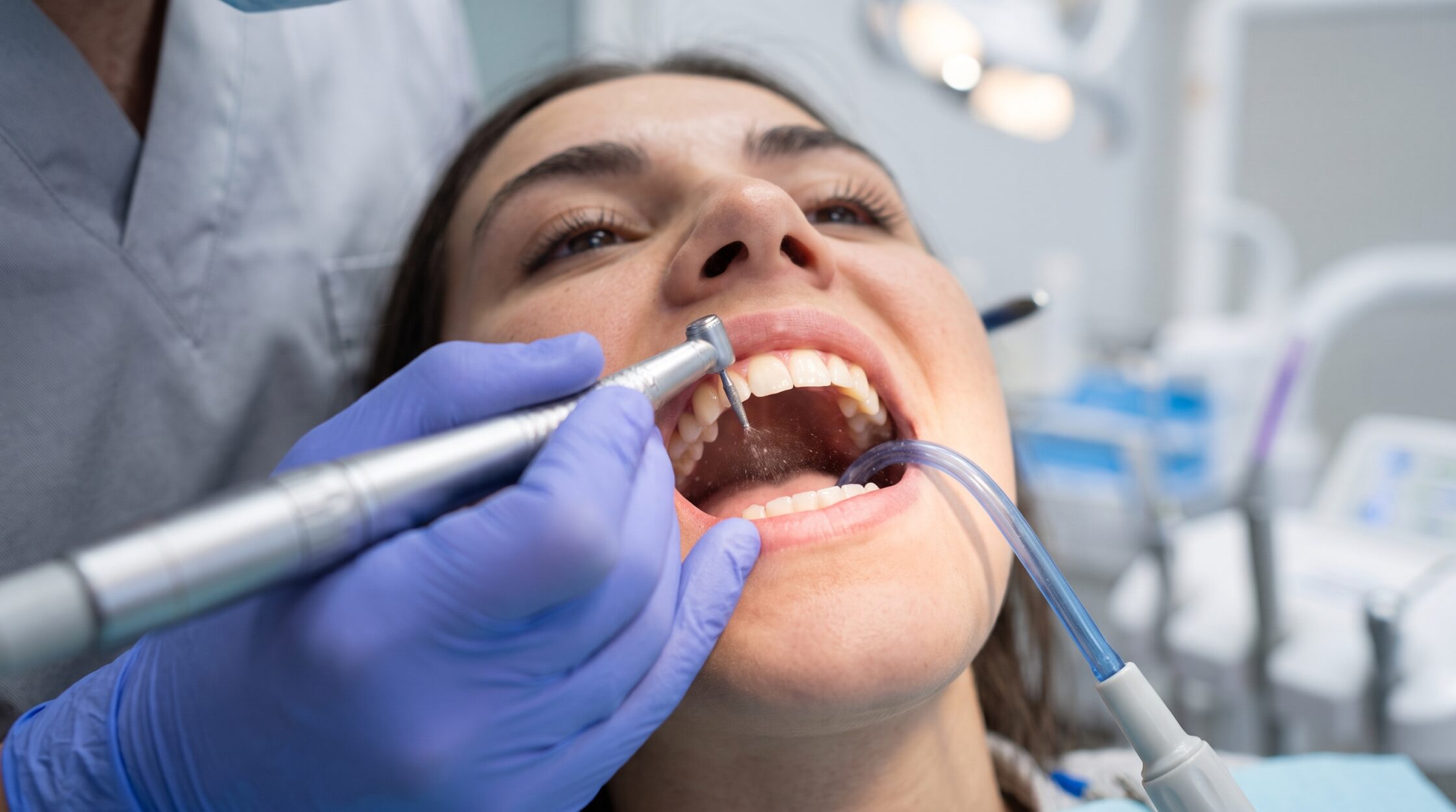 Dentist performing a teeth contouring procedure on a patient